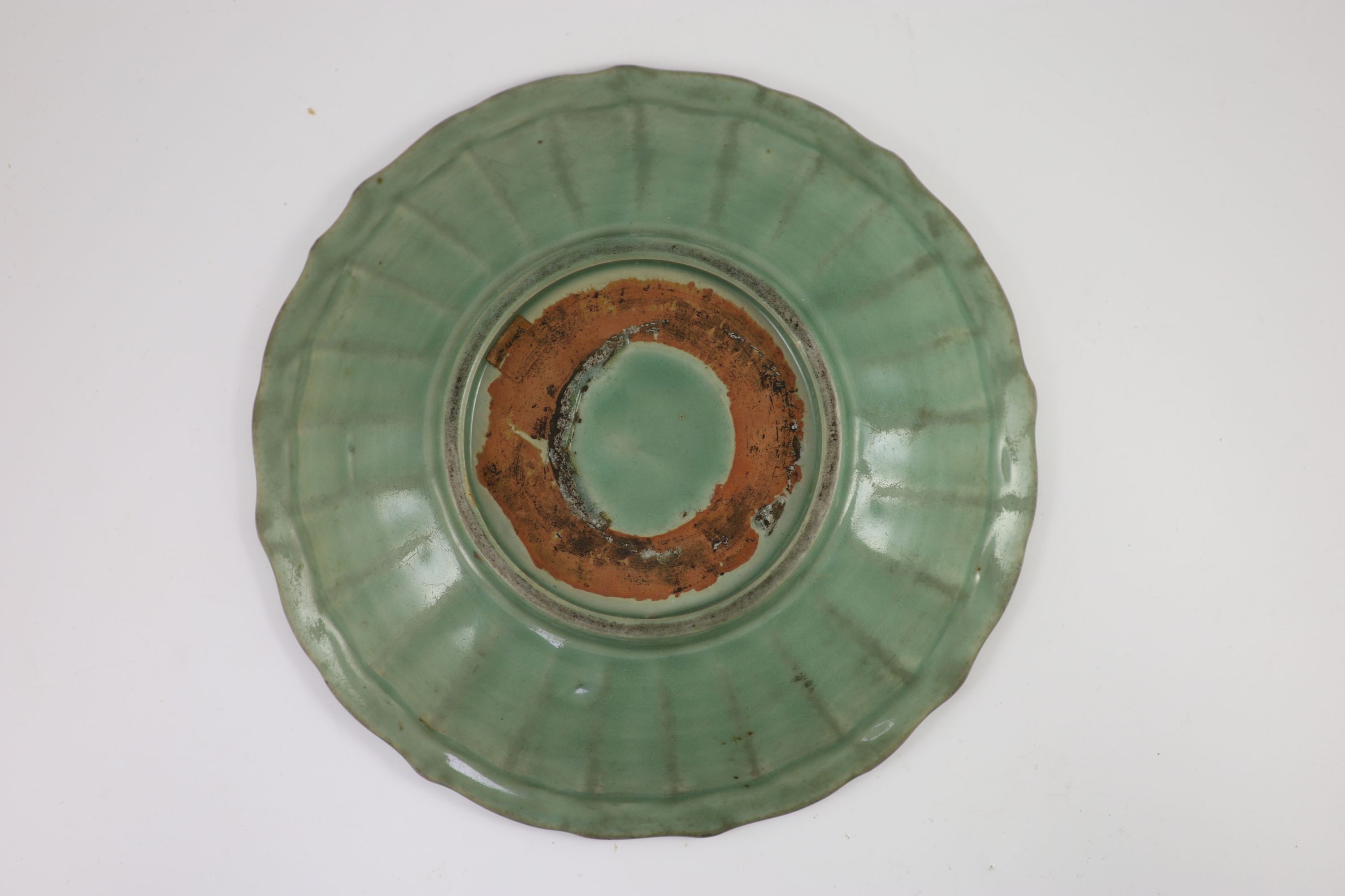 A Chinese Ming Longquan celadon dish, 15th/16th century, 30.5 cm diameter, glaze worn